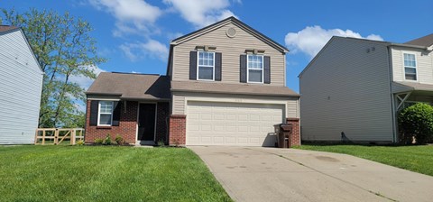 a house with a garage door in front of it